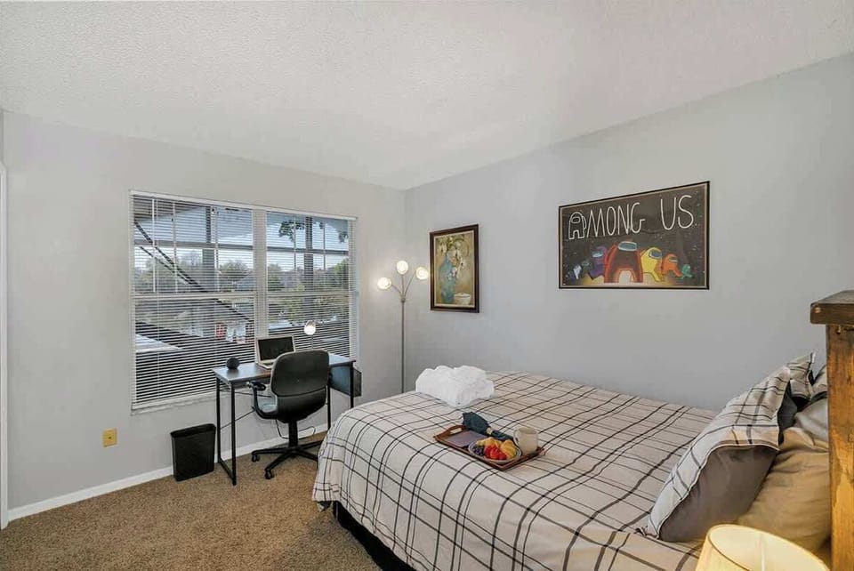 Cozy queen bedroom, large closet, nightstand and desk overlooking the back patio and lake.