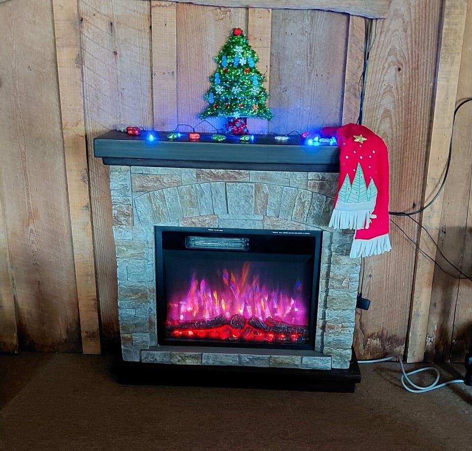 Cozy electric fireplace with plenty of extra blankets in lakefront cottage