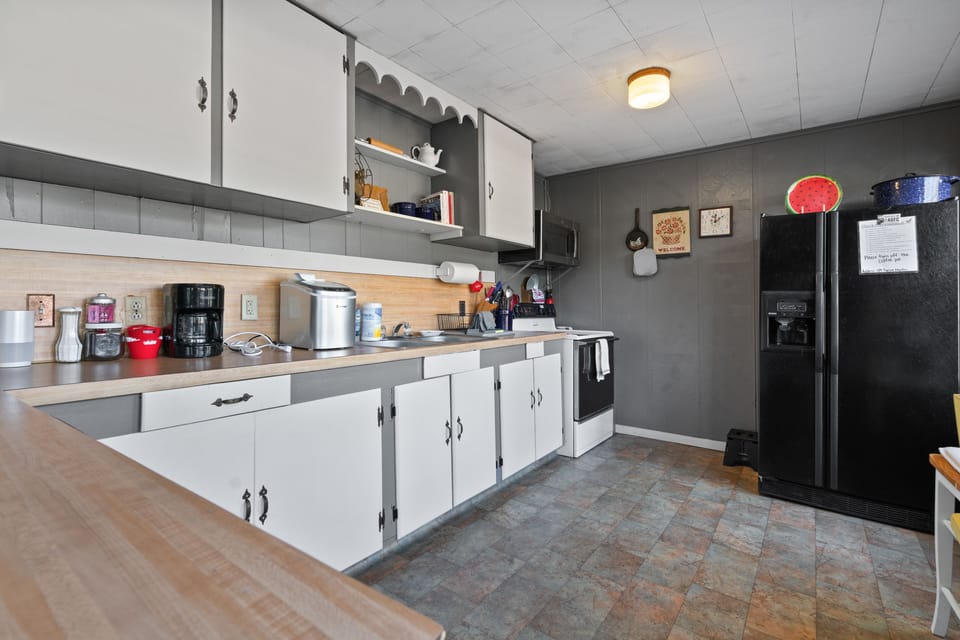 Coffee maker, ice maker, oven, maker, toaster, blender, microwave, and utensils 