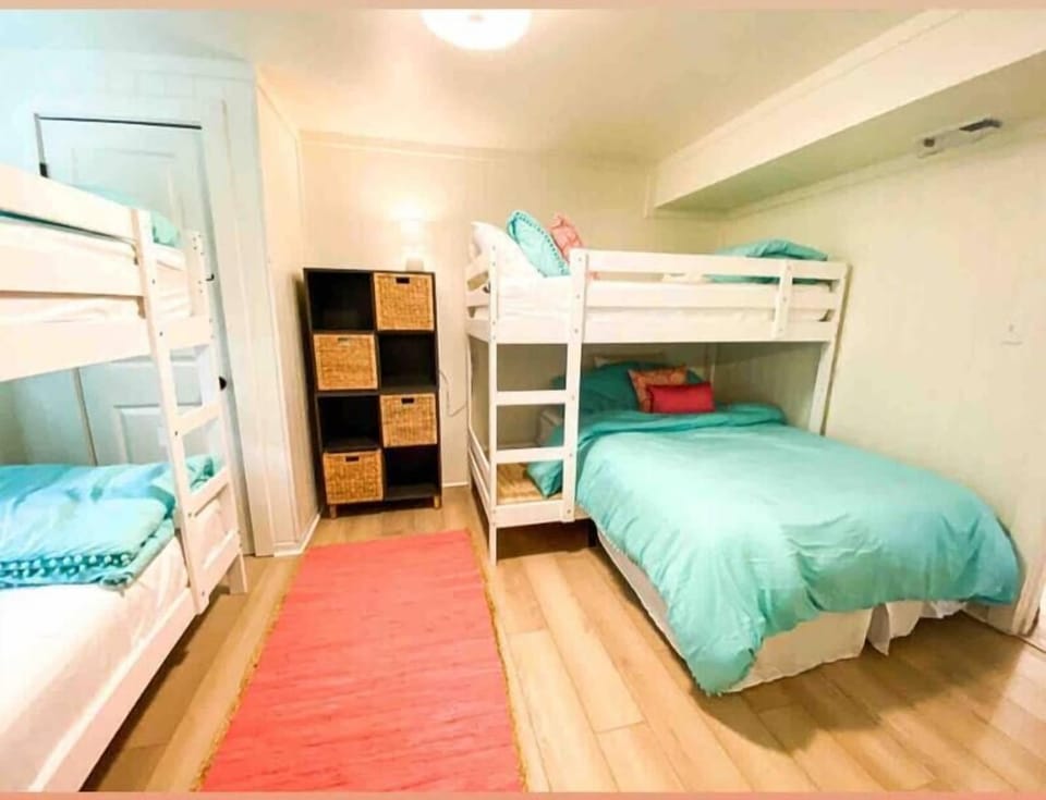 Downstairs bunk room sleeps 5 - 3 twins and one full bed - shared bathroom access