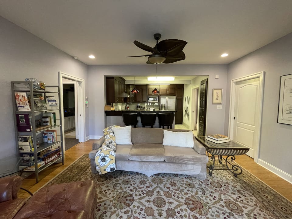 View of living room, eat-at bar, and kitchen from French door entrance.