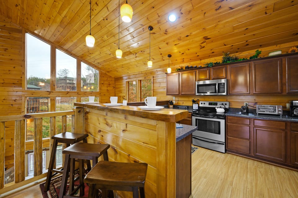 The kitchen counter has three bar height stools for additional seating.