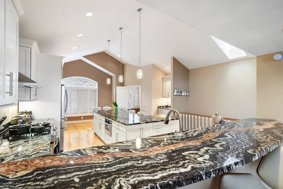 Watch all of the action in the kitchen go down from the bar stools in the living room.