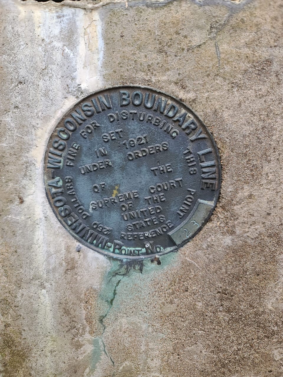 A Wisconsin/Minnesota line marker on our property.