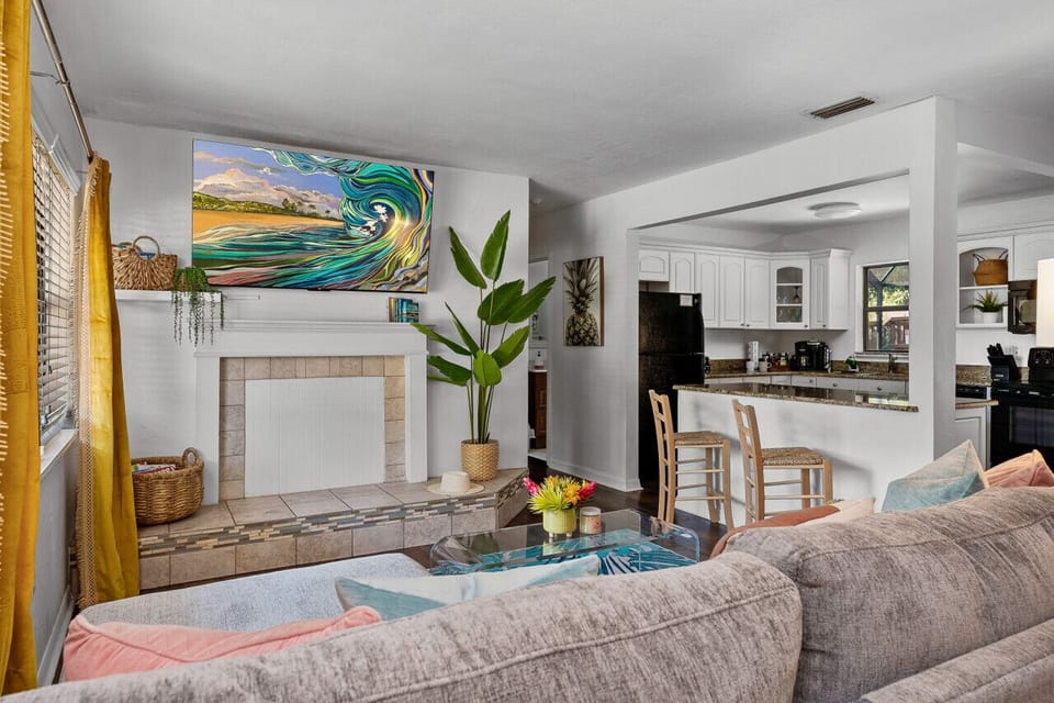 Unwind in style at our Airbnb listing in Tropical Oasis Seminole, featuring a beautiful living room with a comfy couch and stunning painting