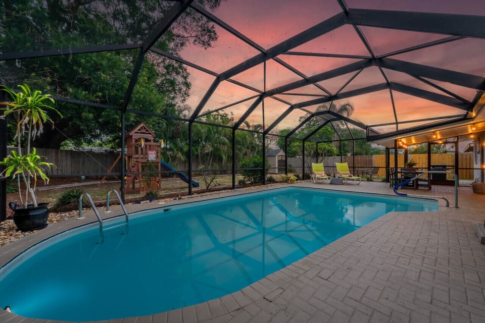 Immerse yourself in pure bliss at this backyard pool, where the sun bids farewell in a mesmerizing display.