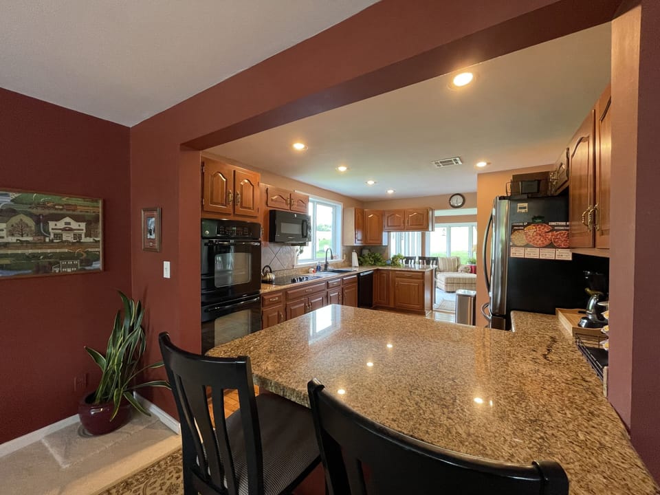 Spacious and luxurious kitchen has double ovens.