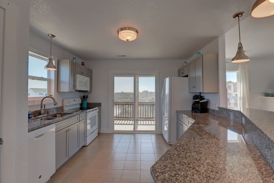 Spacious, fully stocked kitchen with tons of counter space for meal prep