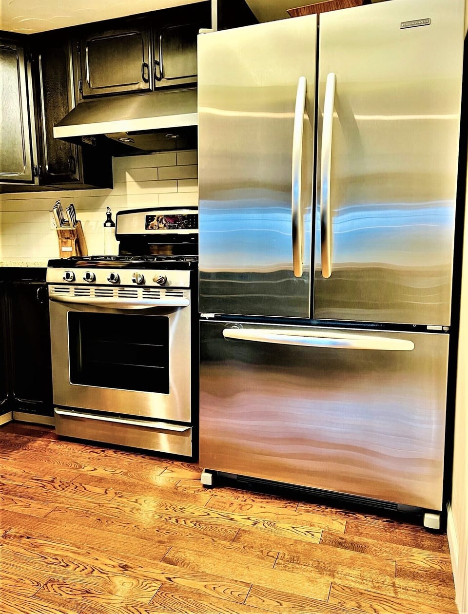 Large stainless-steel refrigerator and oven. 