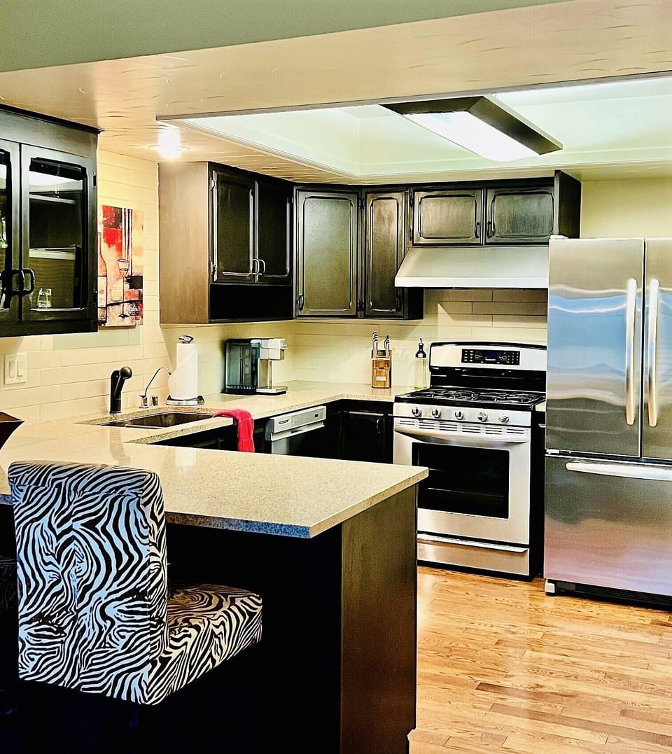 Kitchen area with all stainless-steel appliances and lots of counter space. 