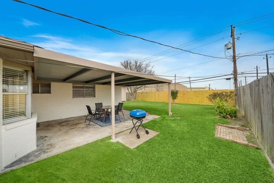 Back Patio Retreat: Sizzle your favorites on the BBQ, surrounded by lush green space!