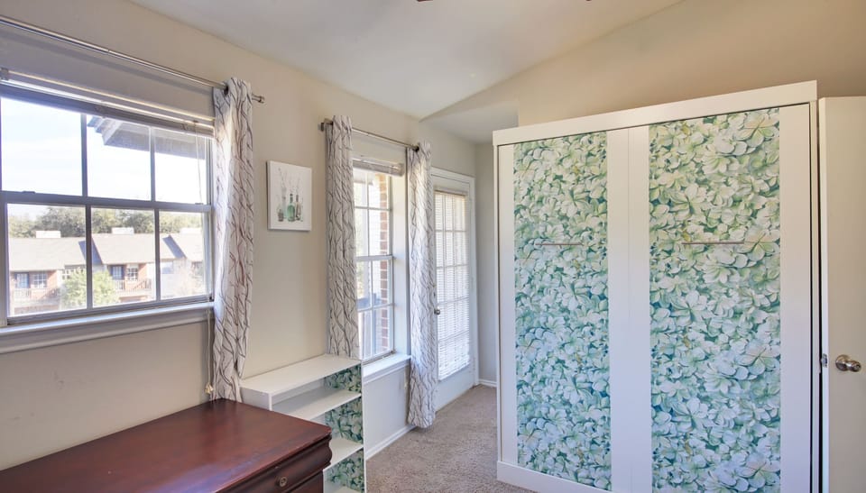 2nd Bedroom/Office with Murphy bed, private en-suite bathroom, balcony, and desk
