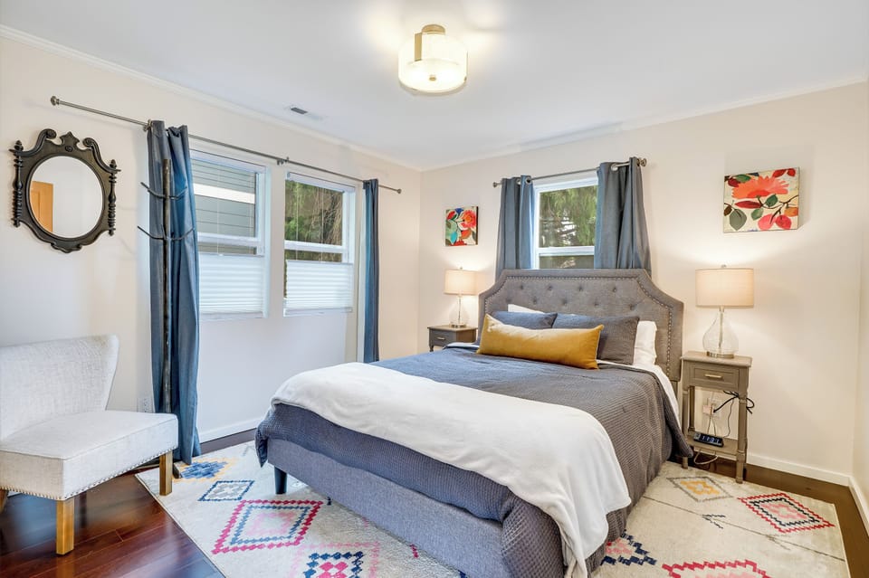 Upstairs bedroom with queen bed and open closet. 