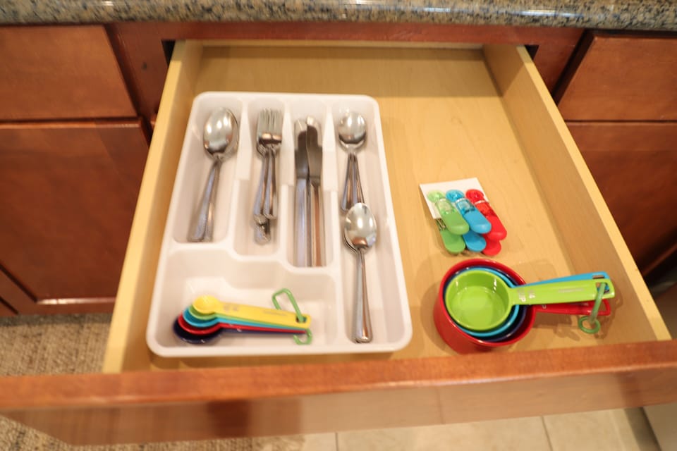 Fully Stocked Silverware inside Kitchen dressers. 