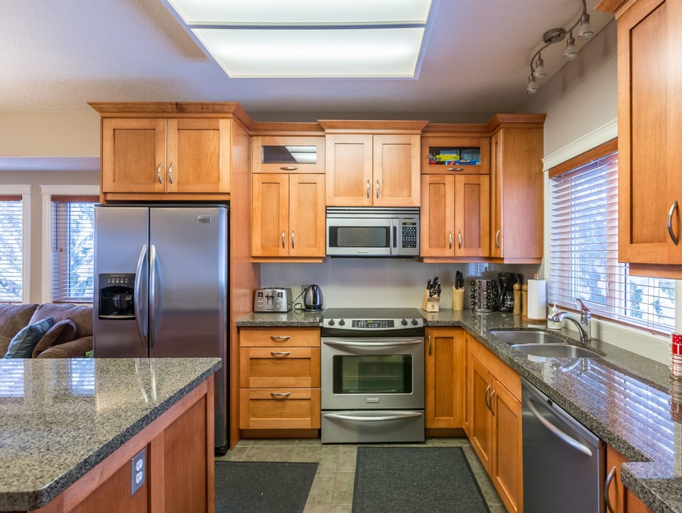 Fully Equipped Kitchen with Stainless Steel Appliances and Granite Counter Tops 