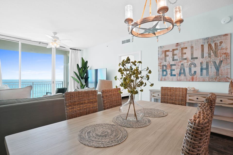 Your beachy dining room opens to stunning ocean views through floor-to-ceiling windows, perfect for morning coffee or sunset dinners.