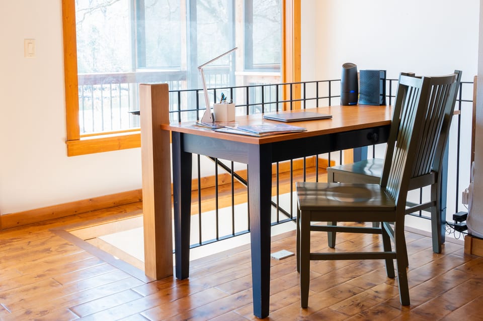 Desk area overlooking the dock and the water. Charging station with cables.