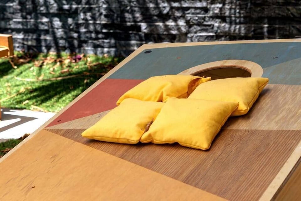 Outdoor cornhole set ready to go — backyard games for the whole group between pool sessions