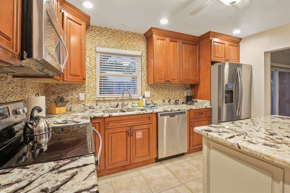 Kitchen with newer appliances, custom cabinets and granite countertops