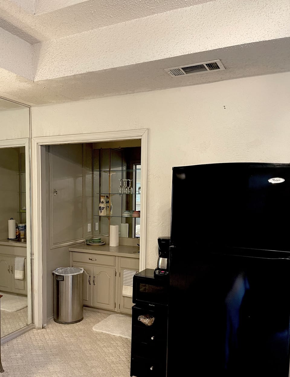 Kitchenette with full refrigerator, microwave, coffee maker and wet bar