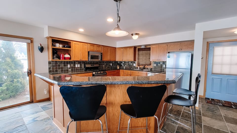 Beautiful kitchen with granite countertops and slate floors. 
