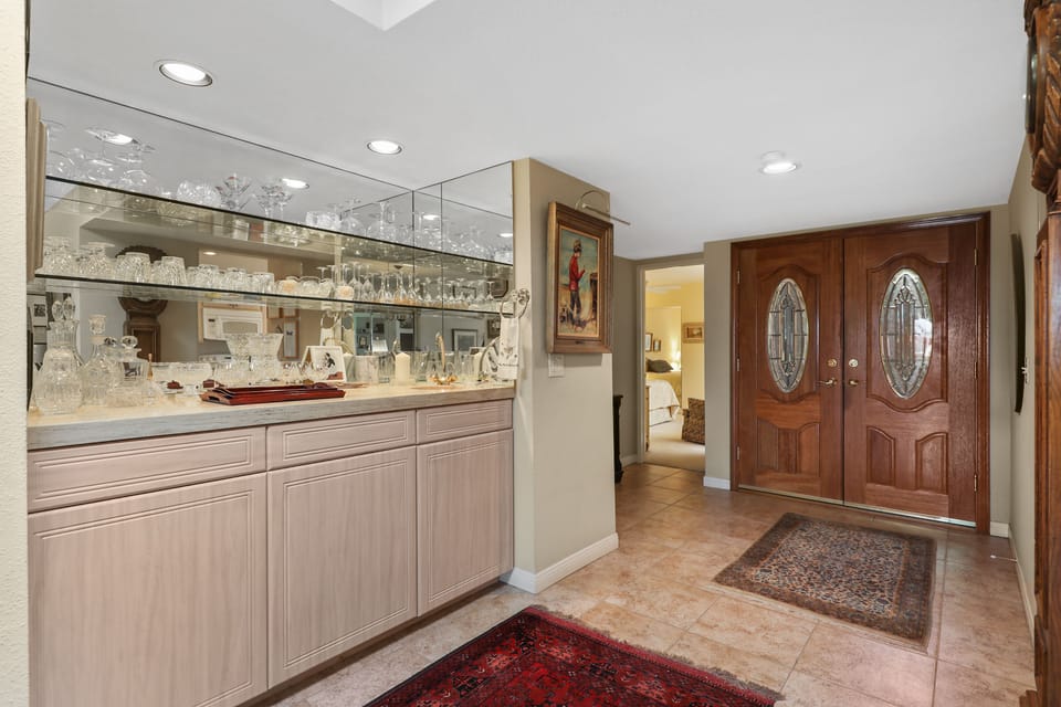 Custom tiled front foyer and view into master bedroom.
