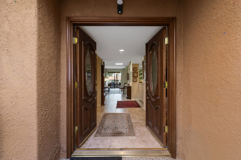 Custom front doors to foyer and view through to rear patio.