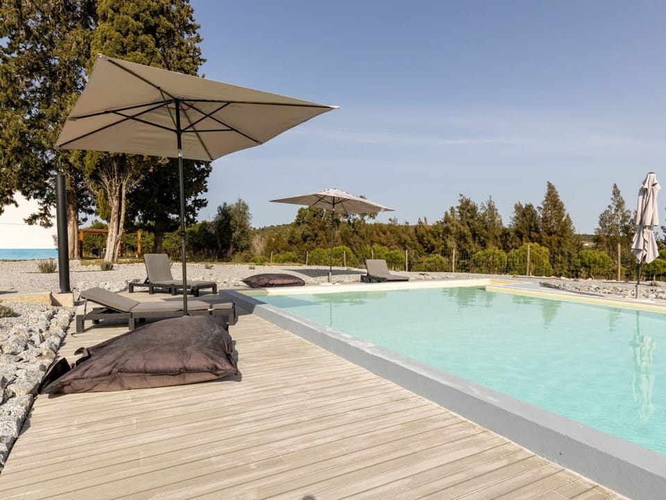 Water, Sky, Plant, Swimming Pool, Tree, Shade, Outdoor Furniture, Sunlounger, Composite Material, Wood