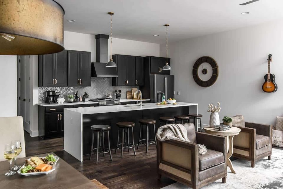 1st Unit - Fully equipped kitchen with stainless steel appliances, large island and bar seating.