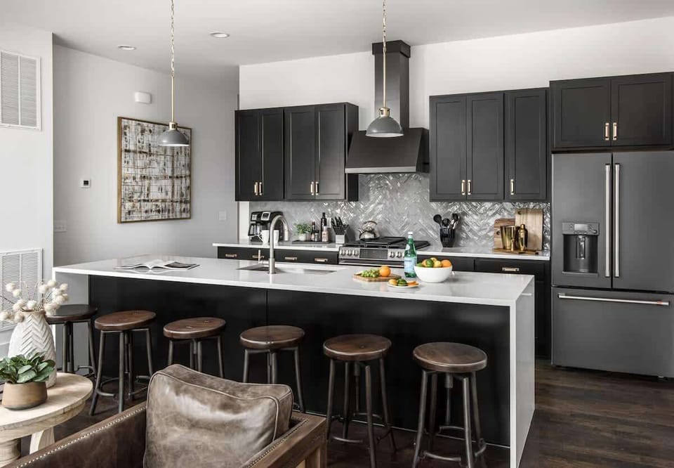 1st Unit - Fully equipped kitchen with stainless steel appliances, large island and bar seating.