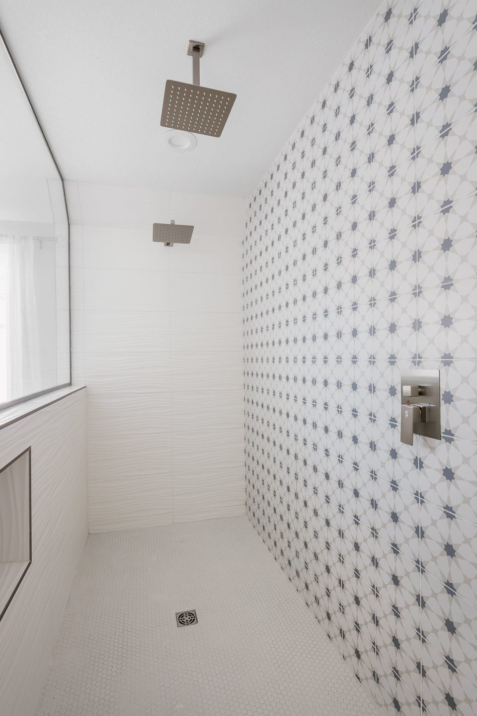 Walk in shower with dual shower heads.