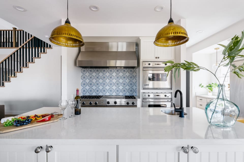 Bright fully equipped kitchen with stainless steel appliances, dual ovens, dual sinks, XL fridge, large island and breakfast table with incredible views of Camelback.