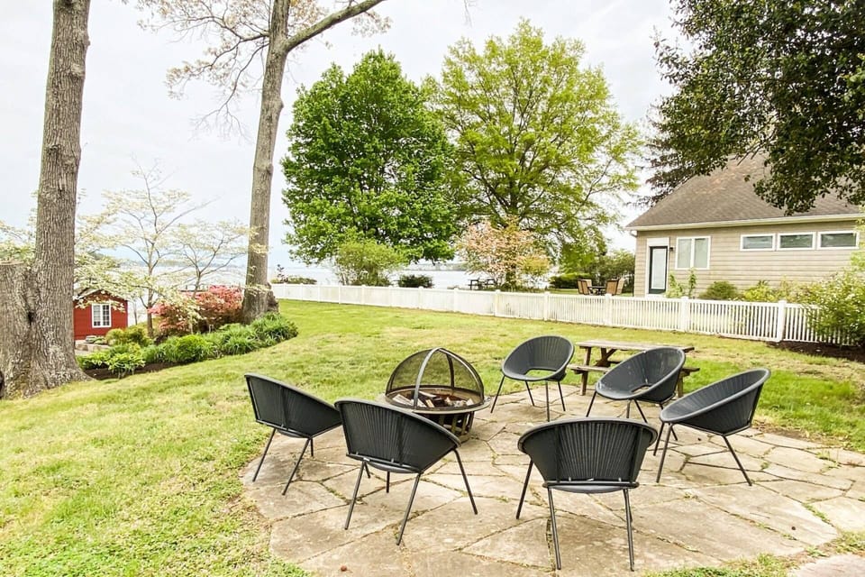 Gather around the waterfront firepit on the artfully-crafted chairs.