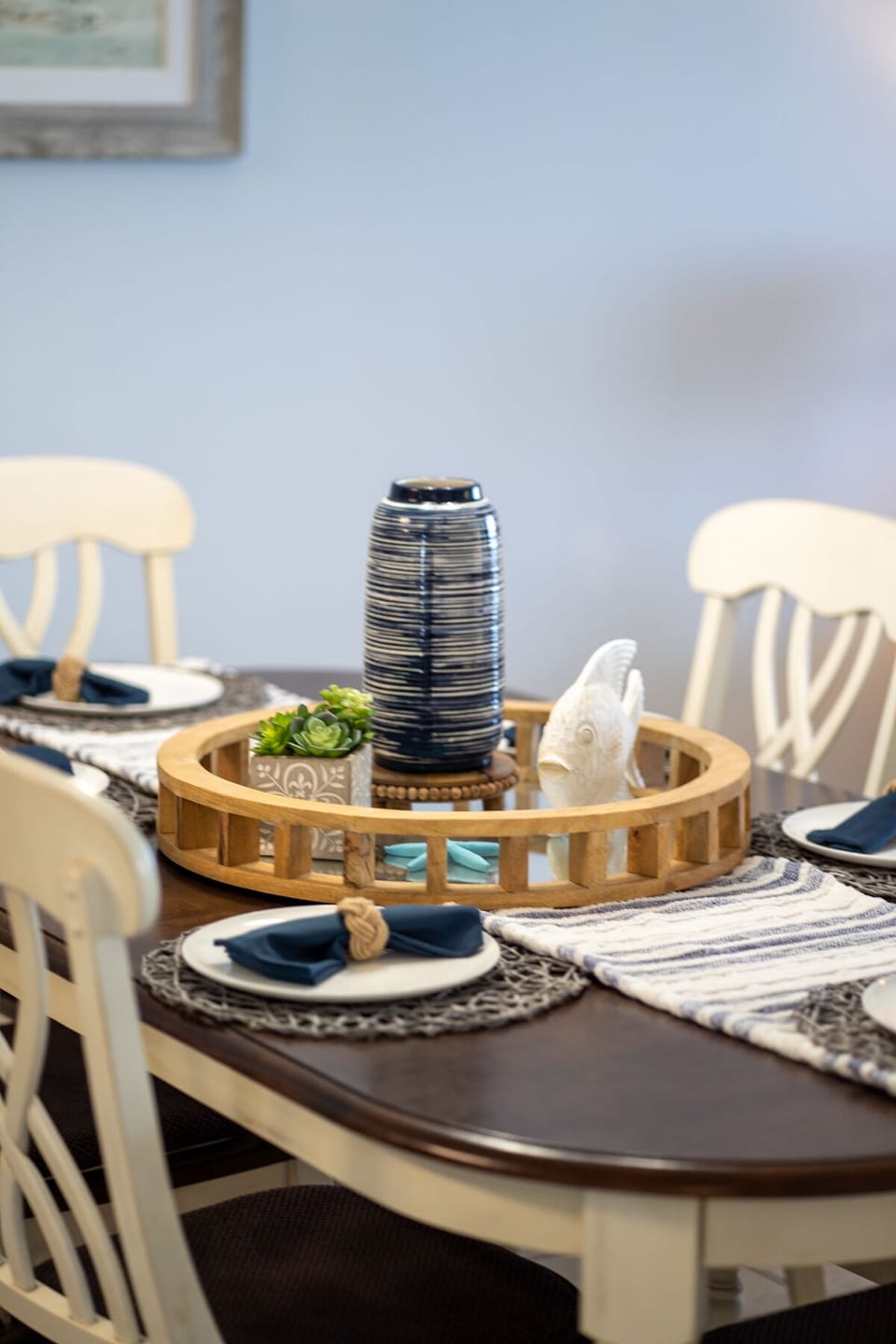 Your elegantly set dining table awaits memorable meals, featuring thoughtful touches and coastal charm that make every gathering special.