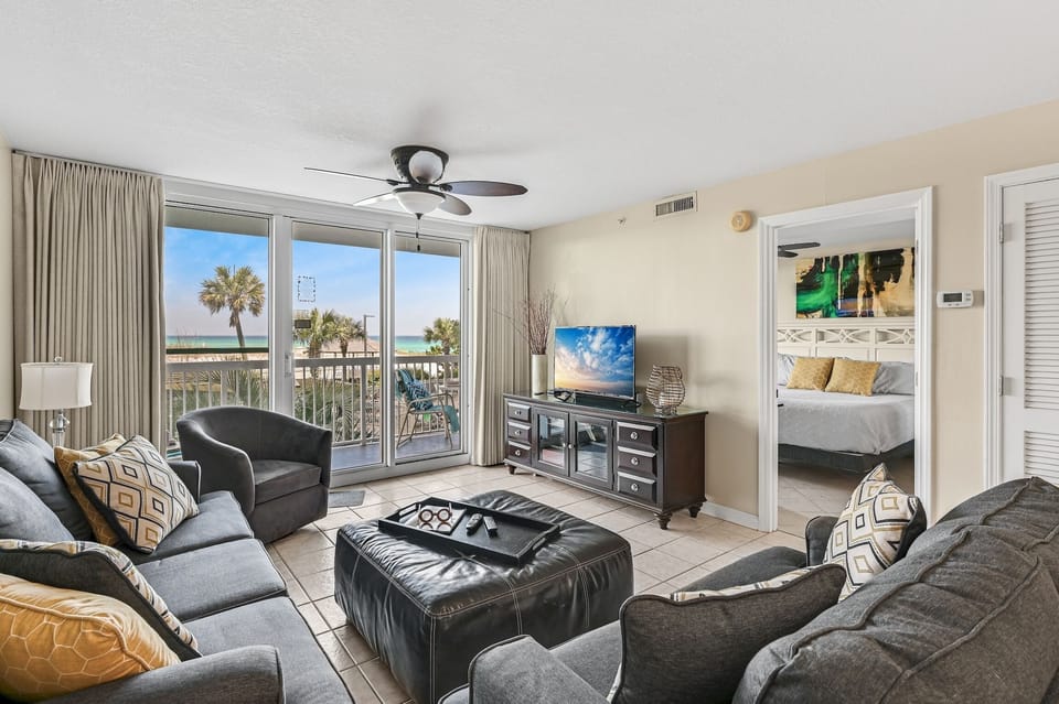 Unwind in your spacious beachfront living room with stunning beach views, comfortable seating, and a private balcony perfect for morning coffee.