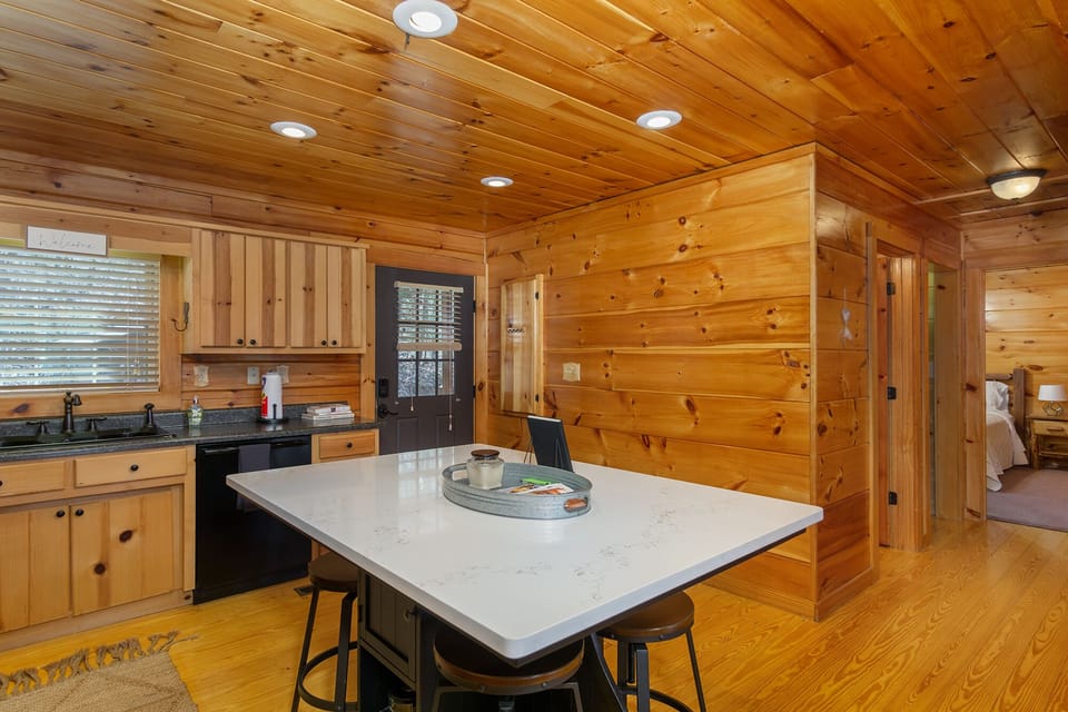 Fully equipped kitchen w/island & bar seating for 4, a  dishwasher, smooth surface stove, standard drip coffeemaker, blender, and waffle maker.