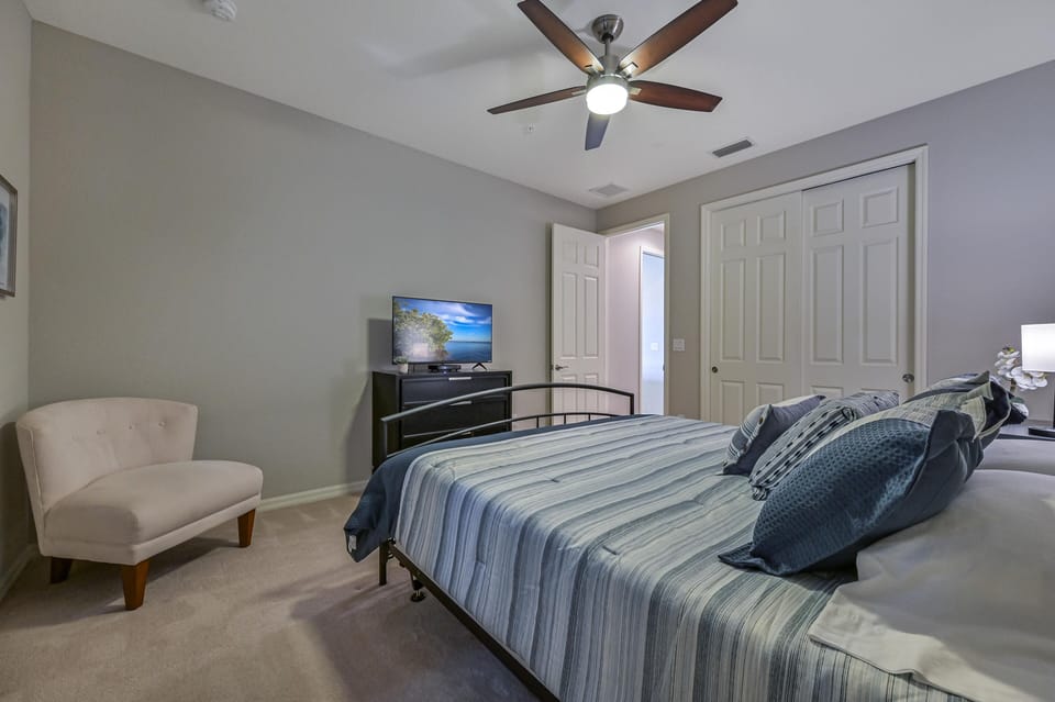 PAS5806 - A king size bed and flat screen TV in the guest bedroom. A pocket door can close off the hallway to the guest bedroom and bathroom and make it into a second master suite