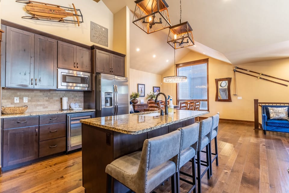 Full-sized kitchen featuring granite countertops, stainless steel appliances, and brand new light fixtures.