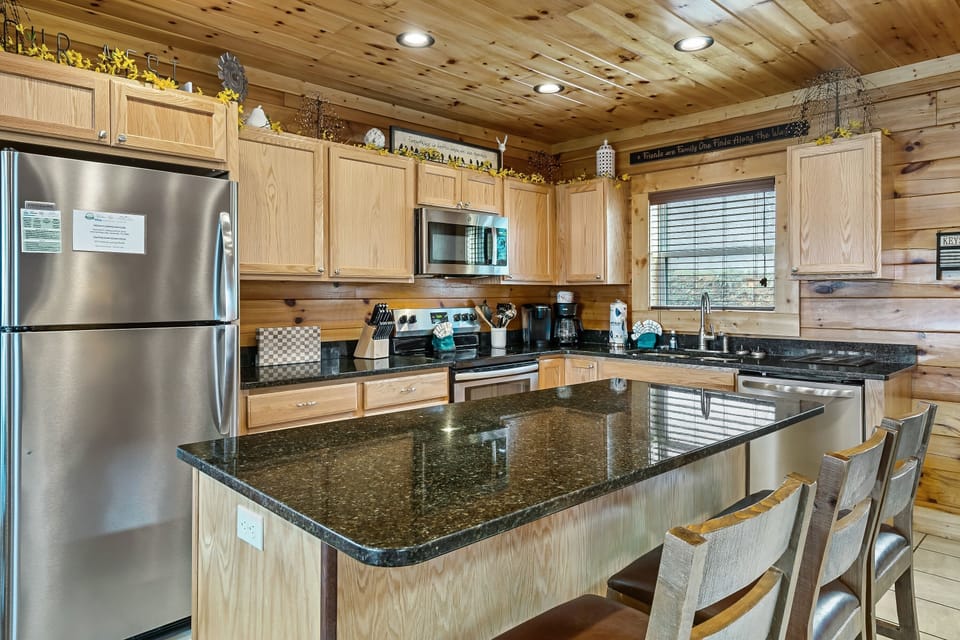 The kitchen is fully stocked with utensils and appliance suitable for light cooking and baking.