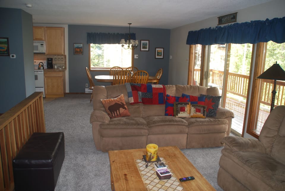 Open living room/dining area.   Lots of windows.