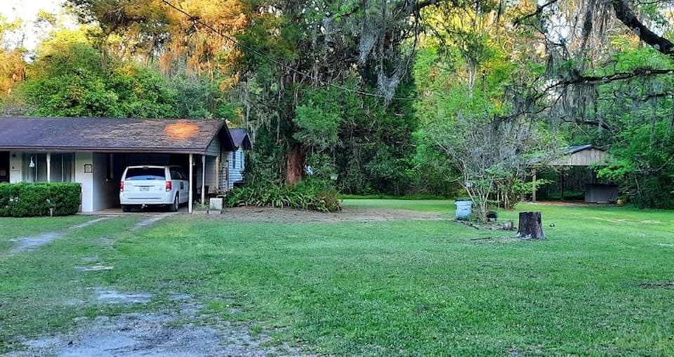Right side of the property in front and on the side of the house