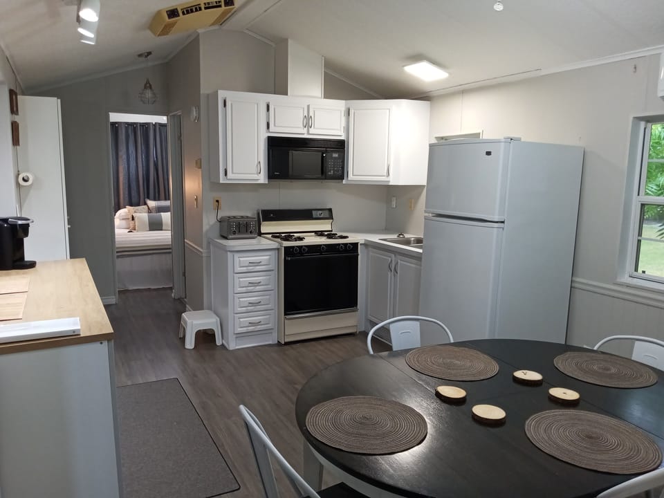 Kitchen and dining table.  Cups, dishes, pots, pans, Keurig, electric kettle 