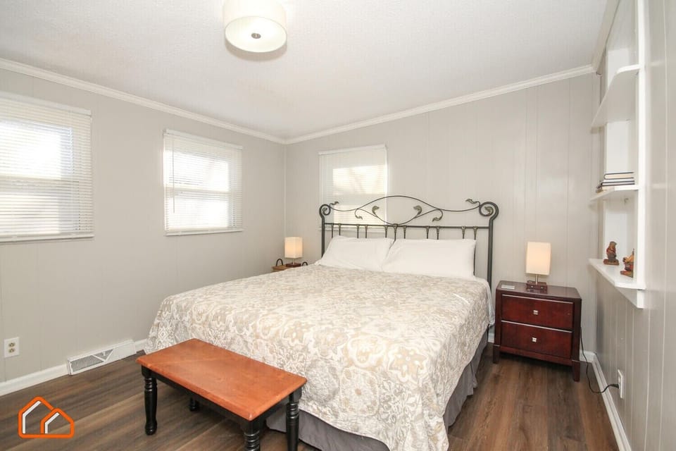Second bedroom with cozy king bed and bedside lamps
