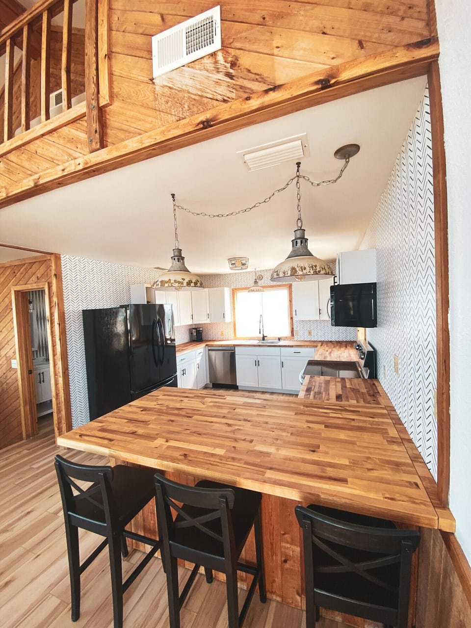 Island area with counter height chairs.