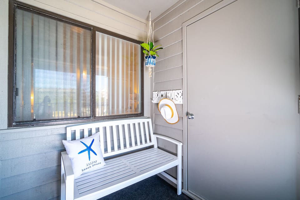 Breezeway porch with new white bench for convenience.