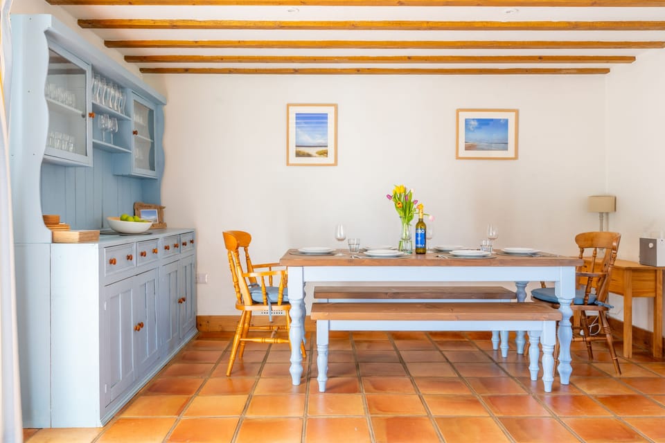 Ground floor: Dining area with chairs and benches