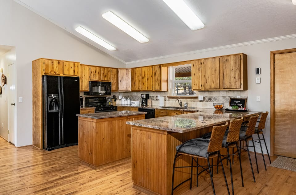 Large kitchen with center island and bar stool seating. 