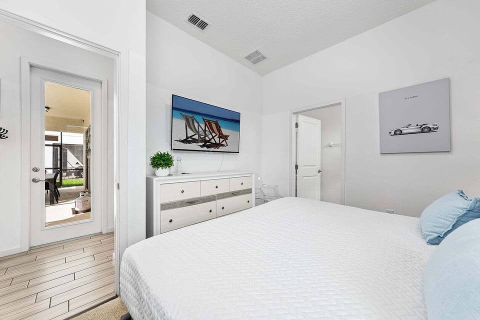 Our fourth bedroom features a king size bed, access to the patio-pool area, TV and full private bathroom.