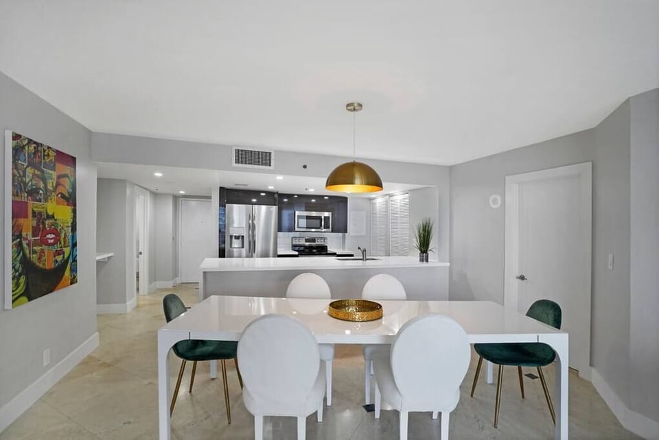 Dining area and view of fully equipped kitchen includes washer/dryer