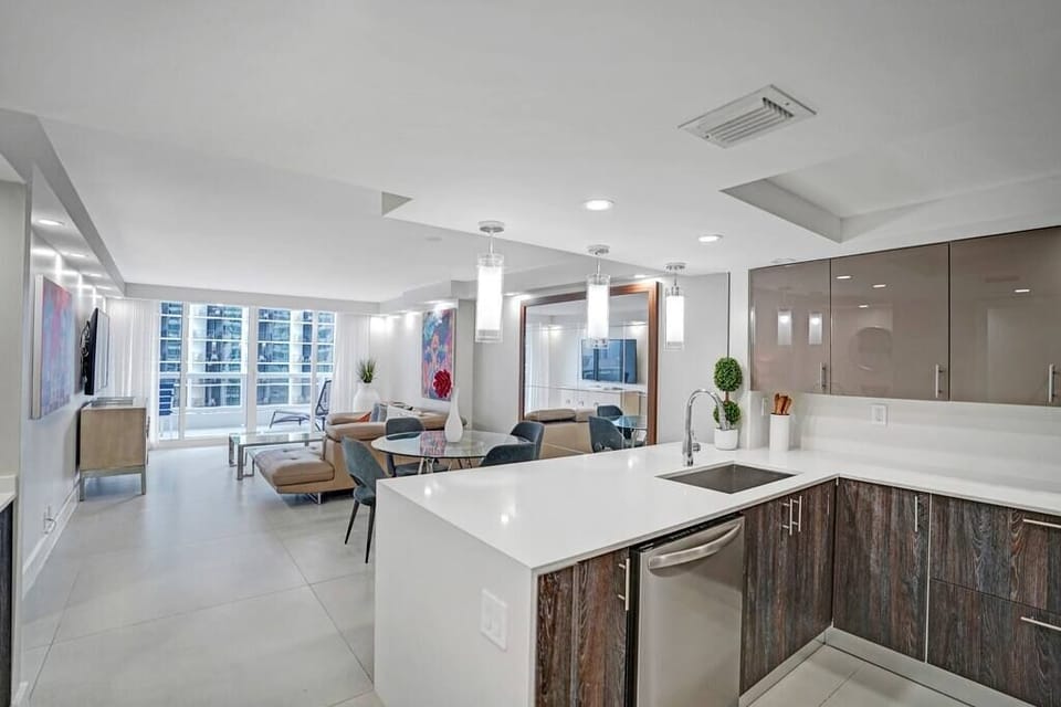 Fully equipped kitchen, washer/dryer, dining area, living room, balcony access